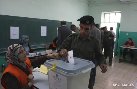A member of Palestinian security forces casts his vote at a polling station in the West bank town of Ramallah, 18 October 2012. The polling stations will be open from seven AM to seven PM for about 13,000 members of the...