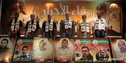 Palestinian Prime Minister in Gaza Ismail Haniyeh (C) attends a ceremony to mark the first anniversary of a deal which saw the exchange of 1,027 Palestinian prisoners for captured Israeli soldier Gilad Shalit, in Gaza ci...