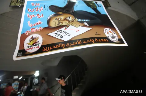 Palestinians attend a ceremony to mark the first anniversary of a deal which saw the exchange of 1,027 Palestinian prisoners for captured Israeli soldier Gilad Shalit, in Gaza city on 18 October 2012. The snatching of Is...