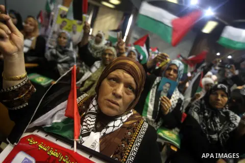 Palestinians attend a ceremony to mark the first anniversary of a deal which saw the exchange of 1,027 Palestinian prisoners for captured Israeli soldier Gilad Shalit, in Gaza city on 18 October 2012. The snatching of Is...
