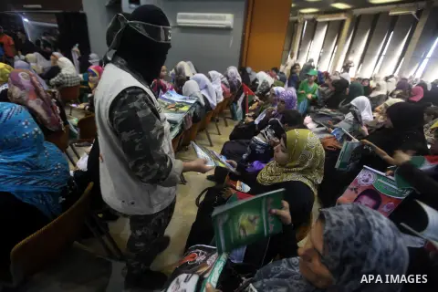 A Palestinian Hamas militant delivers magazines during a ceremony to mark the first anniversary of a deal which saw the exchange of 1,027 Palestinian prisoners for captured Israeli soldier Gilad Shalit, in Gaza city on 1...