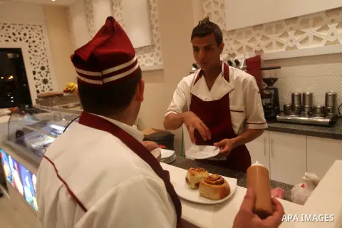 A Palestinian chef puts the final touches on a dessert on October 18, 2012 in the kitchen of the first restaurant that employs deaf people in Gaza, which officially opened earlier this week in Gaza city. The restaurant w...