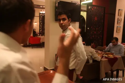A hearing-impaired employee uses sign language to communicate with his co-worker on October 18, 2012 at the first restaurant that employs deaf people in Gaza, which officially opened earlier this week in Gaza city. The r...