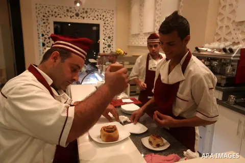 A Palestinian chef puts the final touches on a dessert on October 18, 2012 in the kitchen of the first restaurant that employs deaf people in Gaza, which officially opened earlier this week in Gaza city. The restaurant w...