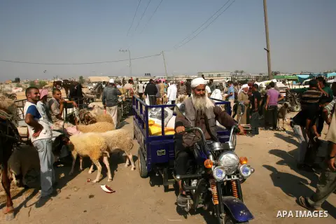 Palestinians trade goats at a local cattle market ahead of Muslim festival of Eid al-Adha, in Rafah in southern Gaza city, on October 20, 2012. Muslims around the world prepare to celebrate Eid Al-Adha, which according t...
