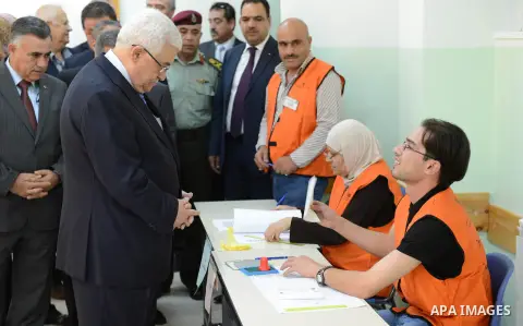 Palestinian President Mahmoud Abbas casts his vote for municipal elections at a polling station in Al-Bireh, next to the West Bank city of Ramallah, October 20, 2012. Photo by Thaer Ganaim