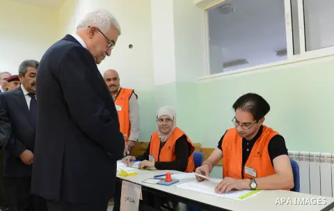 Palestinian President Mahmoud Abbas casts his vote for municipal elections at a polling station in Al-Bireh, next to the West Bank city of Ramallah, October 20, 2012. Photo by Thaer Ganaim