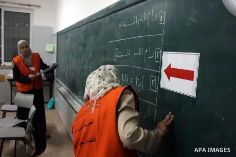 A Palestinian poll official empties a ballot box to start counting the votes at a polling station in the West Bank city of Ramallah on October 20, 2012. Polling stations were closed in the West Bank after 12 hours of vot...