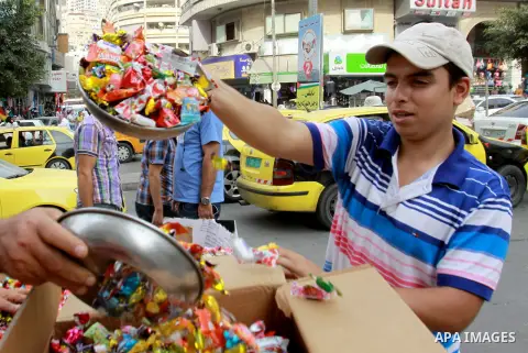 A Palestinian vendor sells candy in preparing to the celebration of Eid al-Adha festival at a market in the West Bank city of Nablus, oct. 21, 2012. Muslims around the world prepare to celebrate Eid Al-Adha, which accord...