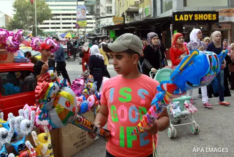 A Palestinian vendor sells ballons in preparing to the celebration of Eid al-Adha festival at a market in the West Bank city of Nablus, oct. 21, 2012. Muslims around the world prepare to celebrate Eid Al-Adha, which acco...
