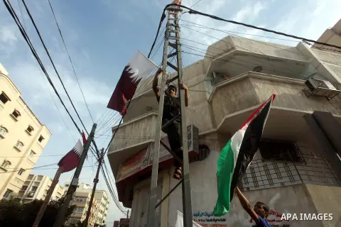 The Qatari and Palestinian (red,black,white, green) flags are attached to lamp posts along a main street in Gaza City on October 21, 2012, the day before the Emir of Qatar's official visit to the strip. Emir of Qatar Ham...