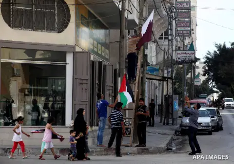 The Qatari and Palestinian (red,black,white, green) flags are attached to lamp posts along a main street in Gaza City on October 21, 2012, the day before the Emir of Qatar's official visit to the strip. Emir of Qatar Ham...