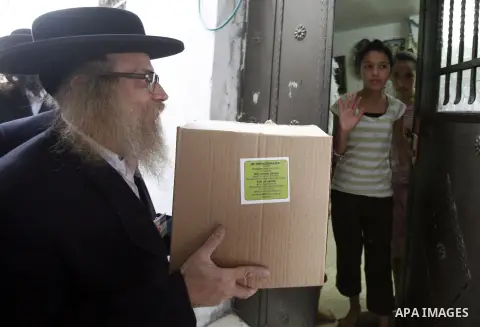 Members of Jewish Neturei Karta deliver humanitarian aid to Palestinian needy families in al-Tur neighborhood in Jerusalem on October. 21, 2012. Neturei Karta opposes Zionism and calls for a peaceful dismantling of the S...