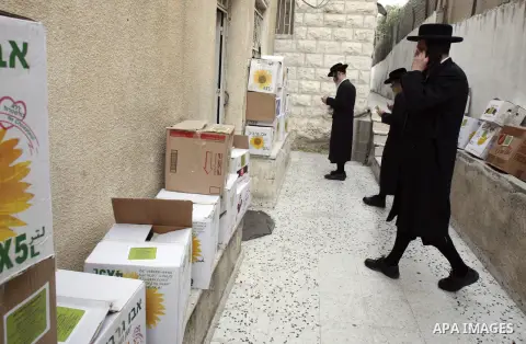 Members of Jewish Neturei Karta deliver humanitarian aid to Palestinian needy families in al-Tur neighborhood in Jerusalem on October. 21, 2012. Neturei Karta opposes Zionism and calls for a peaceful dismantling of the S...