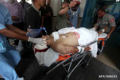 Health workers wheel a wounded Palestinian man from the village of Beit Lahia in the northern Gaza Strip outside the al-Shafa hospital in Gaza City on October 22, 2012, following as Israeli airstrike. Three Palestinians...