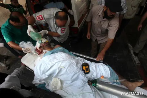 Health workers wheel a wounded Palestinian man from the village of Beit Lahia in the northern Gaza Strip outside the al-Shafa hospital in Gaza City on October 22, 2012, following as Israeli airstrike. Three Palestinians...