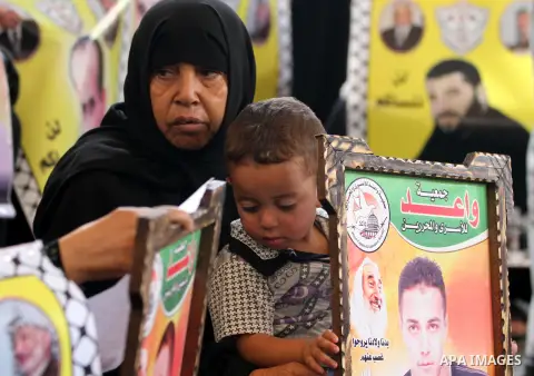 Palestinian women hold pictures of their relatives prisoners held in Israeli jails during a protest calling for their release in front of the red cross office in Gaza city October 22, 2012. Photo by Majdi Fathi