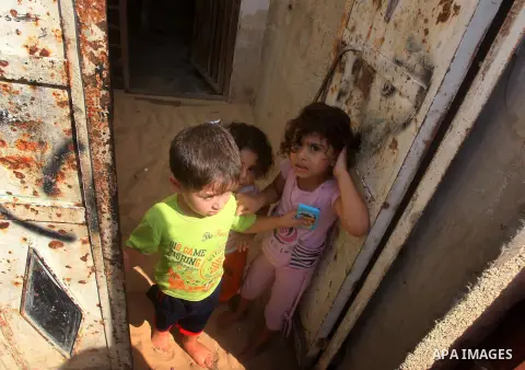 Palestinian children watch the funeral procession of Yasser al-Tarabeen, who was killed in an Israeli air strike in Beit Hanun, in northern Gaza Strip, on October 22, 2012. Israeli air strikes killed two Gaza militants a...