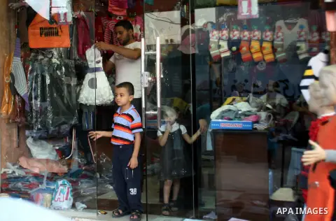 Palestinians shop in preparing to the celebration of Eid al-Adha festival at a market at the main market in Rafah southern Gaza strip, oct. 22, 2012. Muslims around the world prepare to celebrate Eid Al-Adha, which accor...