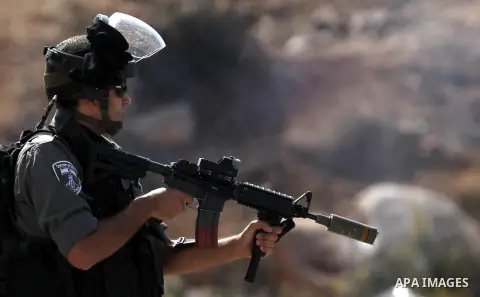 Israeli security forces fire tear gas at Palestinian protesters outside Israel's Ofer military prison, near the West Bank city of Ramallah, on October 22, 2012, following a demonstration in support of Palestinian prisone...