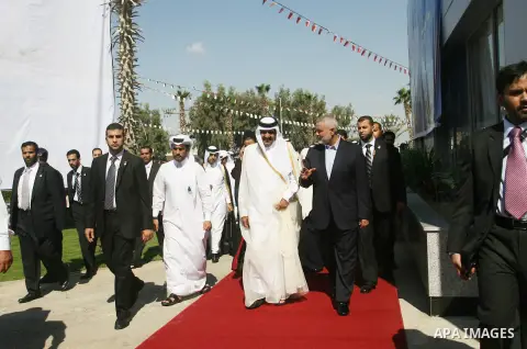 Palestinian Prime Minister in Gaza strip, Ismail Haniyeh walks with the Emir of Qatar Sheik Hamad bin Khalifa al-Thani during a welcoming ceremony at the Rafah border crossing with Egypt in the southern Gaza Strip Octobe...