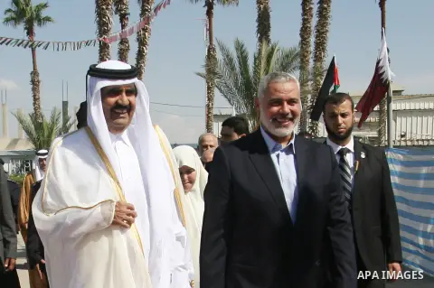 Palestinian Prime Minister in Gaza strip, Ismail Haniyeh walks with the Emir of Qatar Sheik Hamad bin Khalifa al-Thani during a welcoming ceremony at the Rafah border crossing with Egypt in the southern Gaza Strip Octobe...