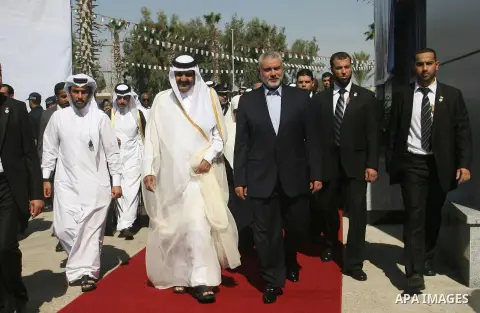 Palestinian Prime Minister in Gaza strip, Ismail Haniyeh walks with the Emir of Qatar Sheik Hamad bin Khalifa al-Thani during a welcoming ceremony at the Rafah border crossing with Egypt in the southern Gaza Strip Octobe...