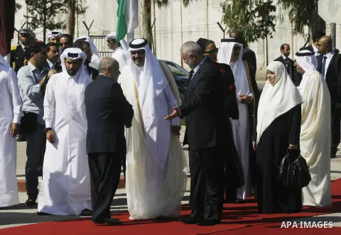Palestinian Prime Minister in Gaza strip, Ismail Haniyeh walks with the Emir of Qatar Sheik Hamad bin Khalifa al-Thani during a welcoming ceremony at the Rafah border crossing with Egypt in the southern Gaza Strip Octobe...