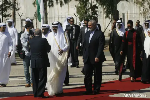 Palestinian Prime Minister in Gaza strip, Ismail Haniyeh walks with the Emir of Qatar Sheik Hamad bin Khalifa al-Thani during a welcoming ceremony at the Rafah border crossing with Egypt in the southern Gaza Strip Octobe...