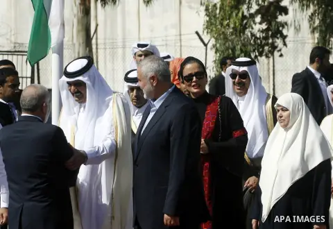 Palestinian Prime Minister in Gaza strip, Ismail Haniyeh walks with the Emir of Qatar Sheik Hamad bin Khalifa al-Thani during a welcoming ceremony at the Rafah border crossing with Egypt in the southern Gaza Strip Octobe...