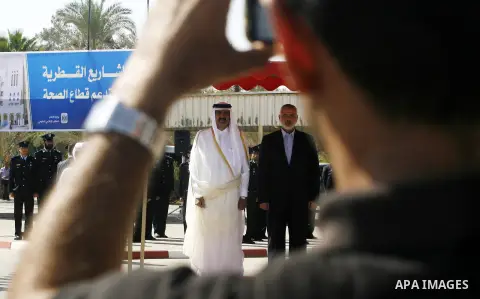 Palestinian Prime Minister in Gaza strip, Ismail Haniyeh walks with the Emir of Qatar Sheik Hamad bin Khalifa al-Thani during a welcoming ceremony at the Rafah border crossing with Egypt in the southern Gaza Strip Octobe...