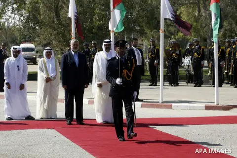 Palestinian Prime Minister in Gaza strip, Ismail Haniyeh walks with the Emir of Qatar Sheik Hamad bin Khalifa al-Thani during a welcoming ceremony at the Rafah border crossing with Egypt in the southern Gaza Strip Octobe...
