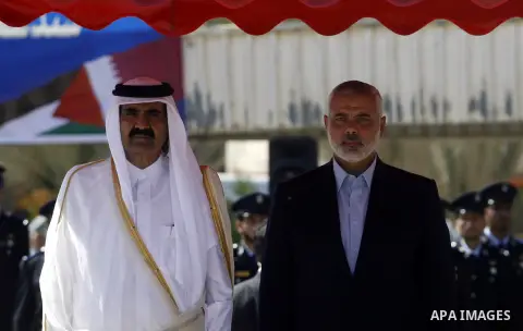 Palestinian Prime Minister in Gaza strip, Ismail Haniyeh walks with the Emir of Qatar Sheik Hamad bin Khalifa al-Thani during a welcoming ceremony at the Rafah border crossing with Egypt in the southern Gaza Strip Octobe...