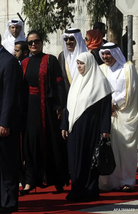 Qatar's First Lady Sheikha Mozah bint Nasser al-Missned and Amal Haniyeh, the wife of Gaza's prime minister Ismail Haniyeh attend a welcome ceremony upon her arrival at the Rafah border crossing with Egypt on October 23,...