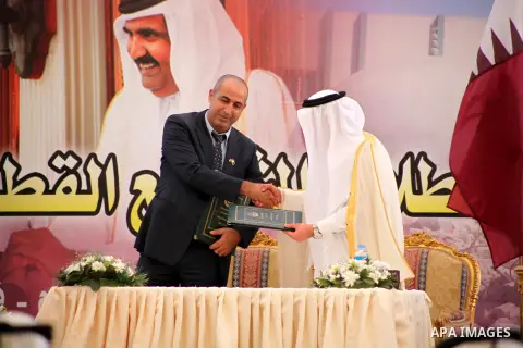 Palestinians and Qataris sign agreements for projects during a cornerstone laying ceremony for Hamad, a new residential neighbourhood in Khan Younis in the southern Gaza Strip, 23 October 2012. The Emir of Qatar entered...