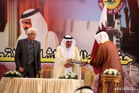 Palestinians and Qataris sign agreements for projects during a cornerstone laying ceremony for Hamad, a new residential neighbourhood in Khan Younis in the southern Gaza Strip, 23 October 2012. The Emir of Qatar entered...