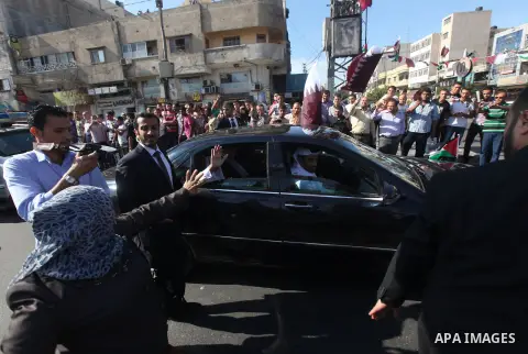 Palestinians gather around the convoy of the Qatari Emir Sheikh Hamad bin Khalifa Al-Thani in Gaza City, Tuesday, Oct. 23,2012. The Emir of Qatar entered the Gaza Strip on Tuesday for a visit that broke the isolation of...