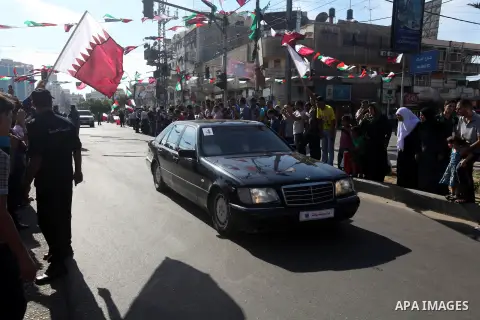 Palestinians gather around the convoy of the Qatari Emir Sheikh Hamad bin Khalifa Al-Thani in Gaza City, Tuesday, Oct. 23,2012. The Emir of Qatar entered the Gaza Strip on Tuesday for a visit that broke the isolation of...