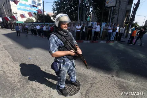 Palestinian Hamas security officers guard a road as they wait for the convoy of the Qatari Emir Sheikh Hamad bin Khalifa Al-Thani to arrive in Gaza City, Tuesday, Oct. 23,2012. The Emir of Qatar entered the Gaza Strip on...
