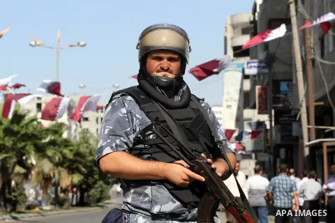 Palestinian Hamas security officers guard a road as they wait for the convoy of the Qatari Emir Sheikh Hamad bin Khalifa Al-Thani to arrive in Gaza City, Tuesday, Oct. 23,2012. The Emir of Qatar entered the Gaza Strip on...
