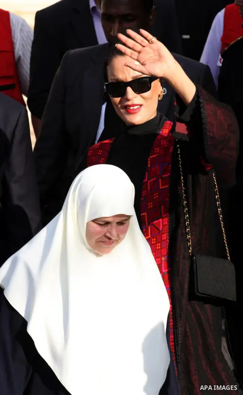 Qatar's First Lady Sheikha Mozah bint Nasser al-Missned leaves the Atfaluna Society for Deaf Children with the wife of Gaza's Hamas prime minister Ismail Haniya in the Gaza Strip on October 23, 2012. The Emir of Qatar en...