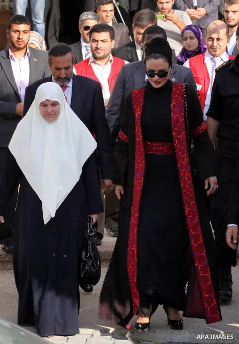 Qatar's First Lady Sheikha Mozah bint Nasser al-Missned leaves the Atfaluna Society for Deaf Children with the wife of Gaza's Hamas prime minister Ismail Haniya in the Gaza Strip on October 23, 2012. The Emir of Qatar en...