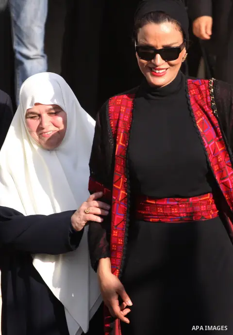 Qatar's First Lady Sheikha Mozah bint Nasser al-Missned leaves the Atfaluna Society for Deaf Children with the wife of Gaza's Hamas prime minister Ismail Haniya in the Gaza Strip on October 23, 2012. The Emir of Qatar en...