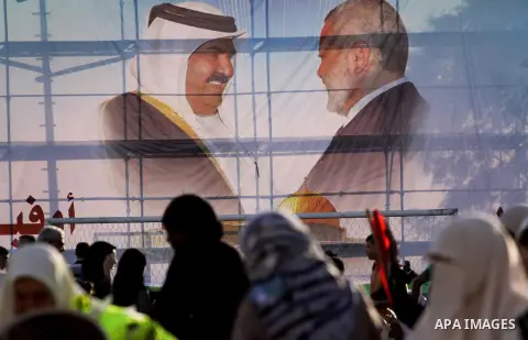 Palestinians stand near posters of the Emir of Qatar Sheikh Hamad bin Khalifa al-Thani in the Gaza city on October 23, 2012. The Emir of Qatar entered the Gaza Strip on Tuesday for a visit that broke the isolation of it...
