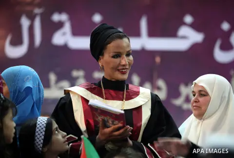 Qatar's First Lady Sheikha Mozah bint Nasser al-Missned stands with the wife of Gaza's prime minister Ismail Haniyah surrounding with Palestinian children at the Islamic University in Gaza city on October 23, 2012. The E...