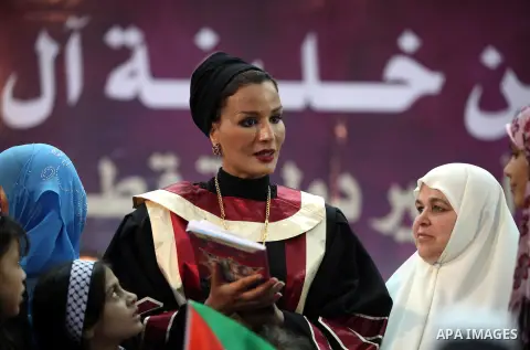 Qatar's First Lady Sheikha Mozah bint Nasser al-Missned stands with the wife of Gaza's prime minister Ismail Haniyah surrounding with Palestinian children at the Islamic University in Gaza city on October 23, 2012. The E...