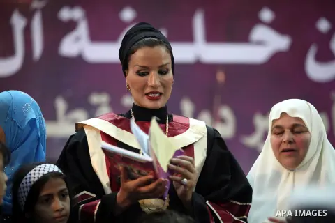 Qatar's First Lady Sheikha Mozah bint Nasser al-Missned stands with the wife of Gaza's prime minister Ismail Haniyah surrounding with Palestinian children at the Islamic University in Gaza city on October 23, 2012. The E...