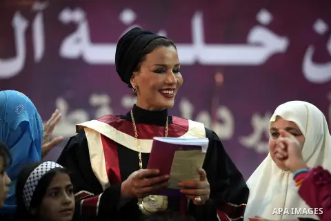 Qatar's First Lady Sheikha Mozah bint Nasser al-Missned stands with the wife of Gaza's prime minister Ismail Haniyah surrounding with Palestinian children at the Islamic University in Gaza city on October 23, 2012. The E...