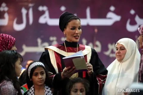 Qatar's First Lady Sheikha Mozah bint Nasser al-Missned stands with the wife of Gaza's prime minister Ismail Haniyah surrounding with Palestinian children at the Islamic University in Gaza city on October 23, 2012. The E...