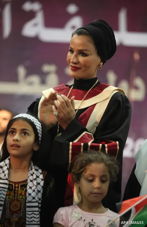 Qatar's First Lady Sheikha Mozah bint Nasser al-Missned stands with the wife of Gaza's prime minister Ismail Haniyah surrounding with Palestinian children at the Islamic University in Gaza city on October 23, 2012. The E...